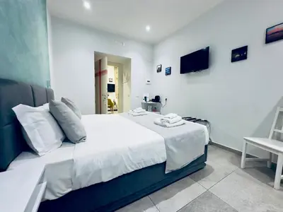 Letto o letti in una camera di Hotiday Napoli Centro