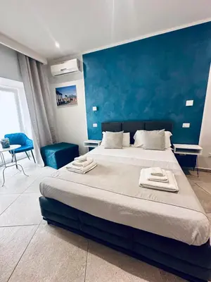 Letto o letti in una camera di Hotiday Napoli Centro