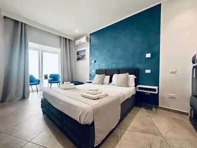 Letto o letti in una camera di Hotiday Napoli Centro