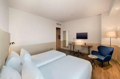 Letto o letti in una camera di NH Napoli Panorama