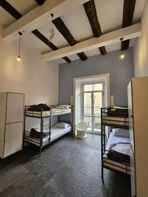 Letto o letti in una camera di La Controra Hostel Naples