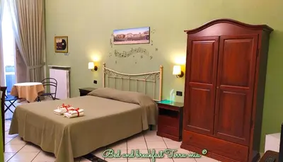 Letto o letti in una camera di B&B Terra Mia Napoli