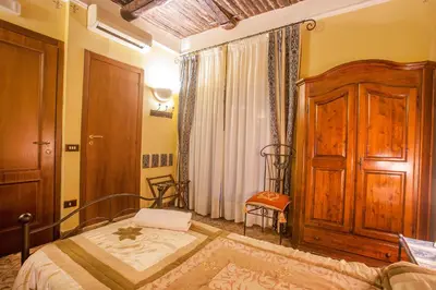 Letto o letti in una camera di B&B L'Alloggio Dei Vassalli