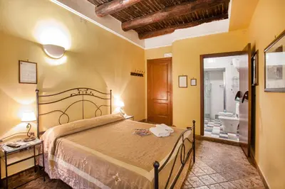 Letto o letti in una camera di B&B L'Alloggio Dei Vassalli