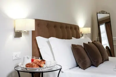 Letto o letti in una camera di La Fontanina Suites