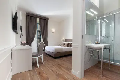 Letto o letti in una camera di La Fontanina Suites