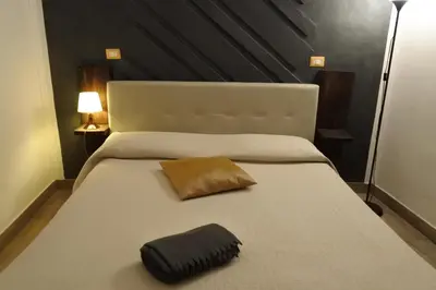 Letto o letti in una camera di BHome Fashion Suite