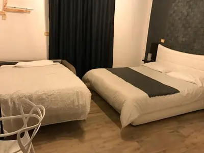Letto o letti in una camera di BHome Fashion Suite
