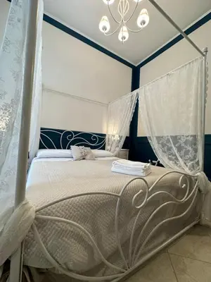 Letto o letti in una camera di B&B Pantarei Napoli