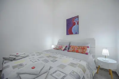 Letto o letti in una camera di MIRANDA APARTMENTS nel cuore del Vomero