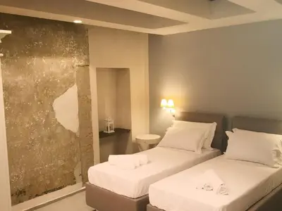 Letto o letti in una camera di Vicoli di Napoli B&B