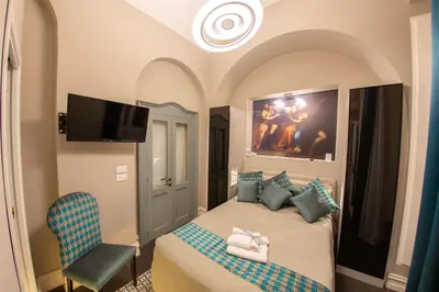 Letto o letti in una camera di Leone Camere D'autore - CHIAIA