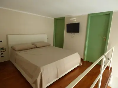 Letto o letti in una camera di le case della baia di Napoli