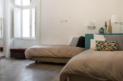 Letto o letti in una camera di Manuela Apartments Piazza del Plebiscito Centro