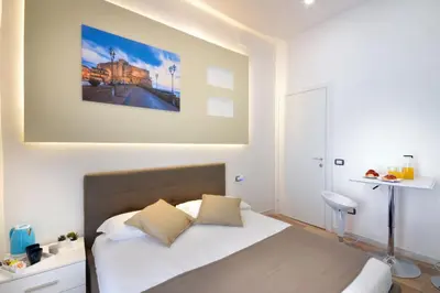 Letto o letti in una camera di B&BCentral Station Napoli
