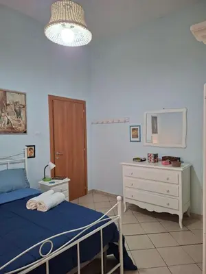 Letto o letti in una camera di Casa Vacanze Donna Manu- Centralissima Tra Stazione Centrale ed Aeroporto