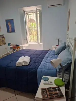 Letto o letti in una camera di Casa Vacanze Donna Manu- Centralissima Tra Stazione Centrale ed Aeroporto