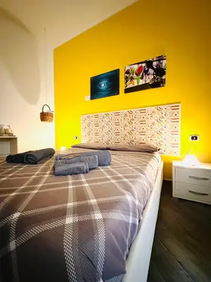 Letto o letti in una camera di B&B Cosmoneapolitan