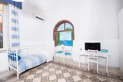 Letto o letti in una camera di Napoli Experience