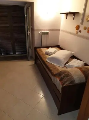 Letto o letti in una camera di CASA MARGHERITA