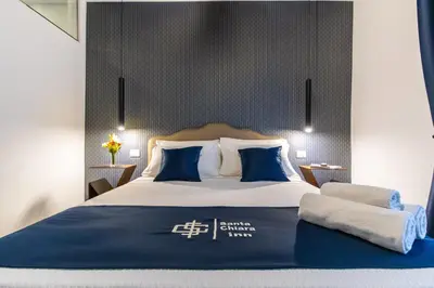 Letto o letti in una camera di Santa Chiara Inn