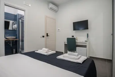 Letto o letti in una camera di Doria Suites Napoli