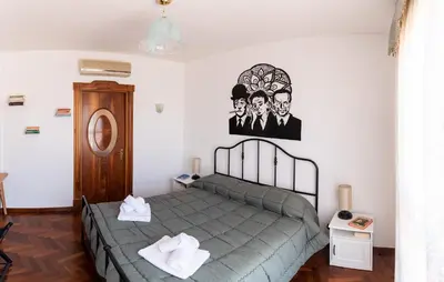 Letto o letti in una camera di L'Attico Fuggente