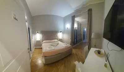 Letto o letti in una camera di Alcaprì Suite Napoli Centro