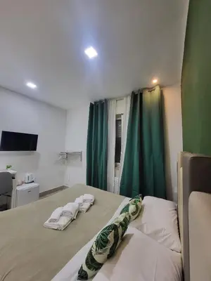 Letto o letti in una camera di New Era Rooms