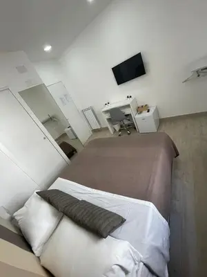 Letto o letti in una camera di New Era Rooms