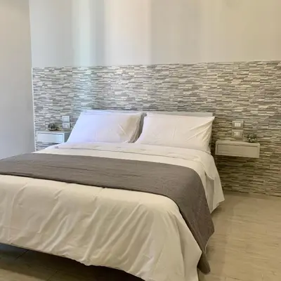 Letto o letti in una camera di Naptown Rooms