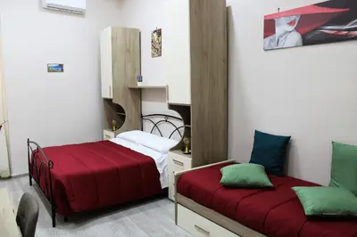 Letto o letti in una camera di Essenza di Napoli