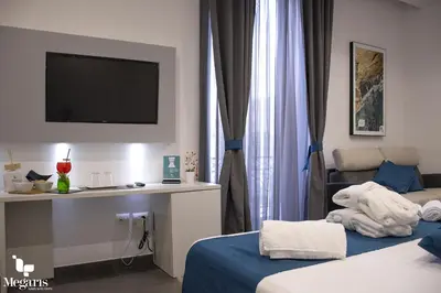 Letto o letti in una camera di Megaris Luxury Suite Rooms