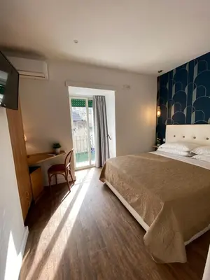 Letto o letti in una camera di Hotel Europeo Napoli