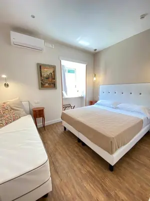 Letto o letti in una camera di Hotel Europeo Napoli
