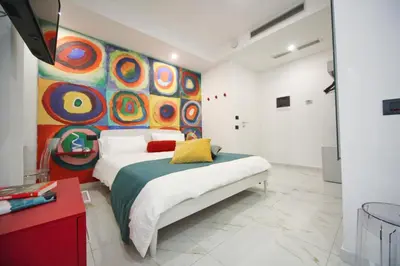 Letto o letti in una camera di Be Coloured - Boutique Art Rooms in Naples