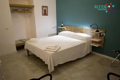 Letto o letti in una camera di Alfieri Apartment