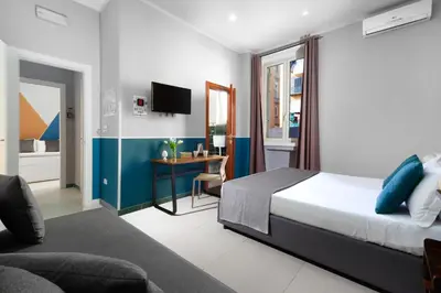 Letto o letti in una camera di ROYAL ROOMS STATION NAPOLI