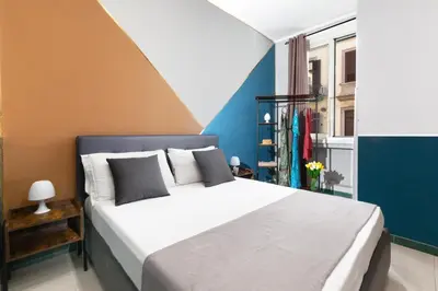 Letto o letti in una camera di ROYAL ROOMS STATION NAPOLI