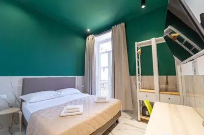 Letto o letti in una camera di P.C. Boutique H. De Gasperi, Napoli Centro, by ClaPa Group