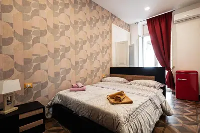 Letto o letti in una camera di Vacanze Partenopee - San Liborio