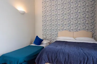 Letto o letti in una camera di B&B Donna Adelina