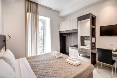 Letto o letti in una camera di Napoli Suite