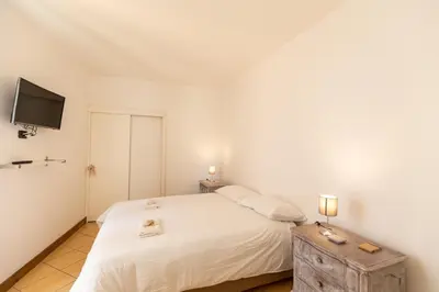 Letto o letti in una camera di COLORED HOUSE UNTIL 7 PEOPLE ABOVE SqPLEBISCITO