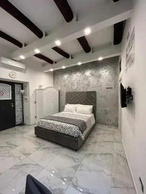 Letto o letti in una camera di Casa Tolentino al centro di Napoli