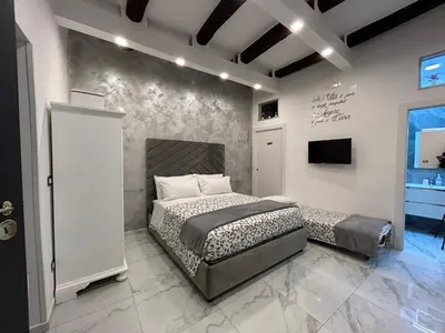 Letto o letti in una camera di Casa Tolentino al centro di Napoli