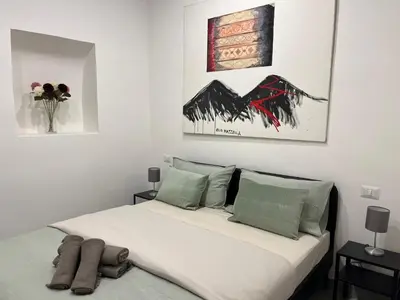 Letto o letti in una camera di SORRISO SUITE