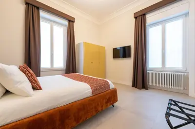 Letto o letti in una camera di Palazzo Massa Apartments